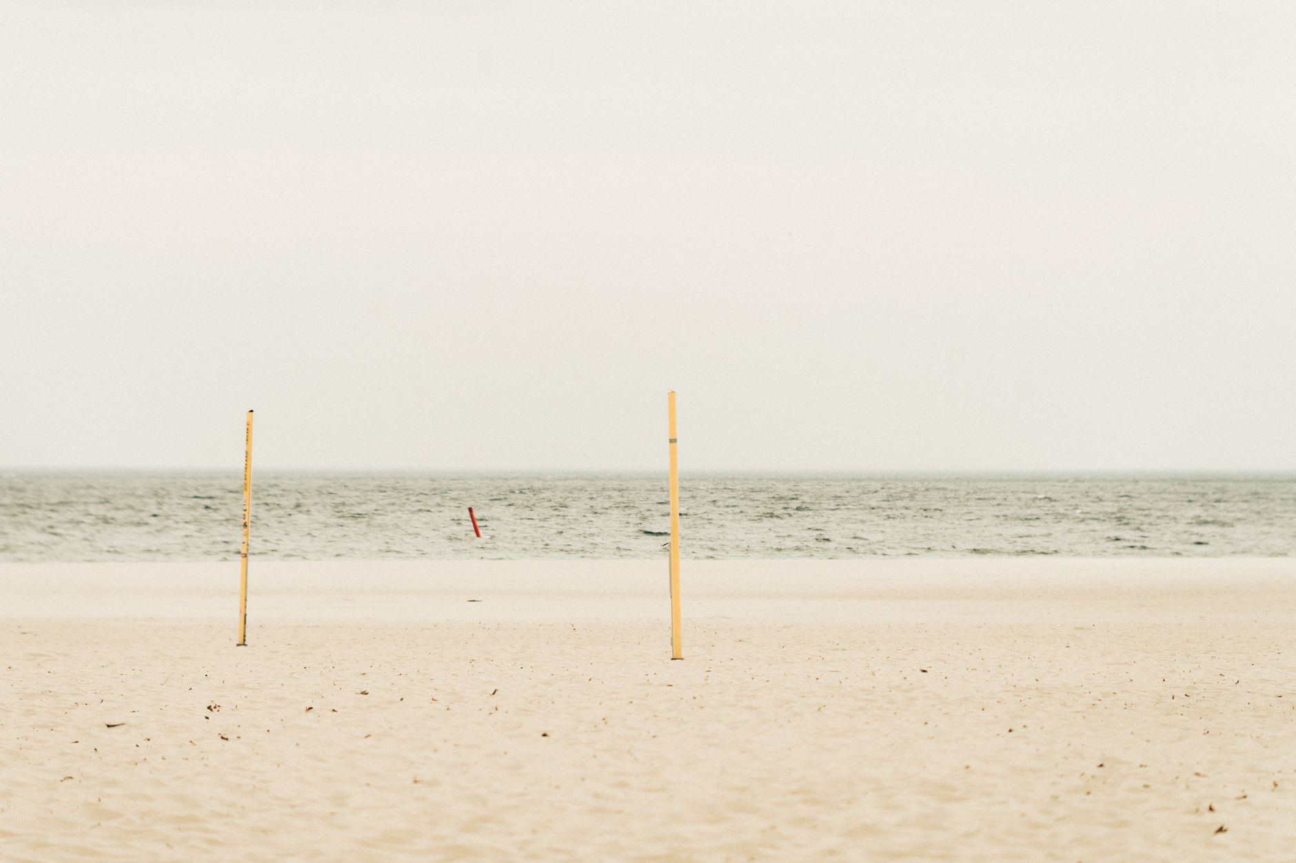 Serene view of an empty beach under a cloudy sky in Gdynia, Poland, ideal for meditation.