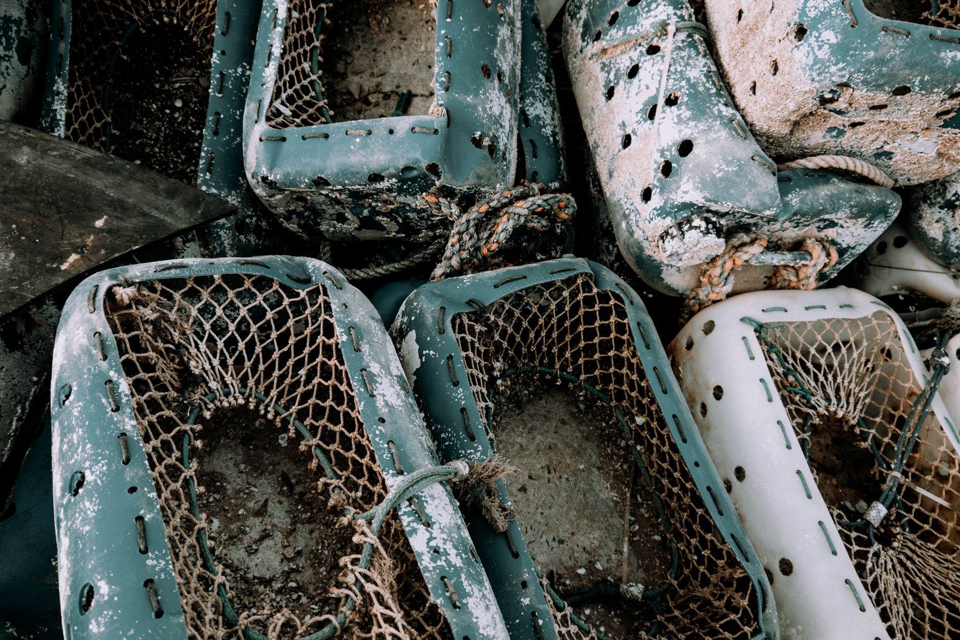 Detailed close-up of rustic fishing gear showcasing texture and wear with a focus on nets.