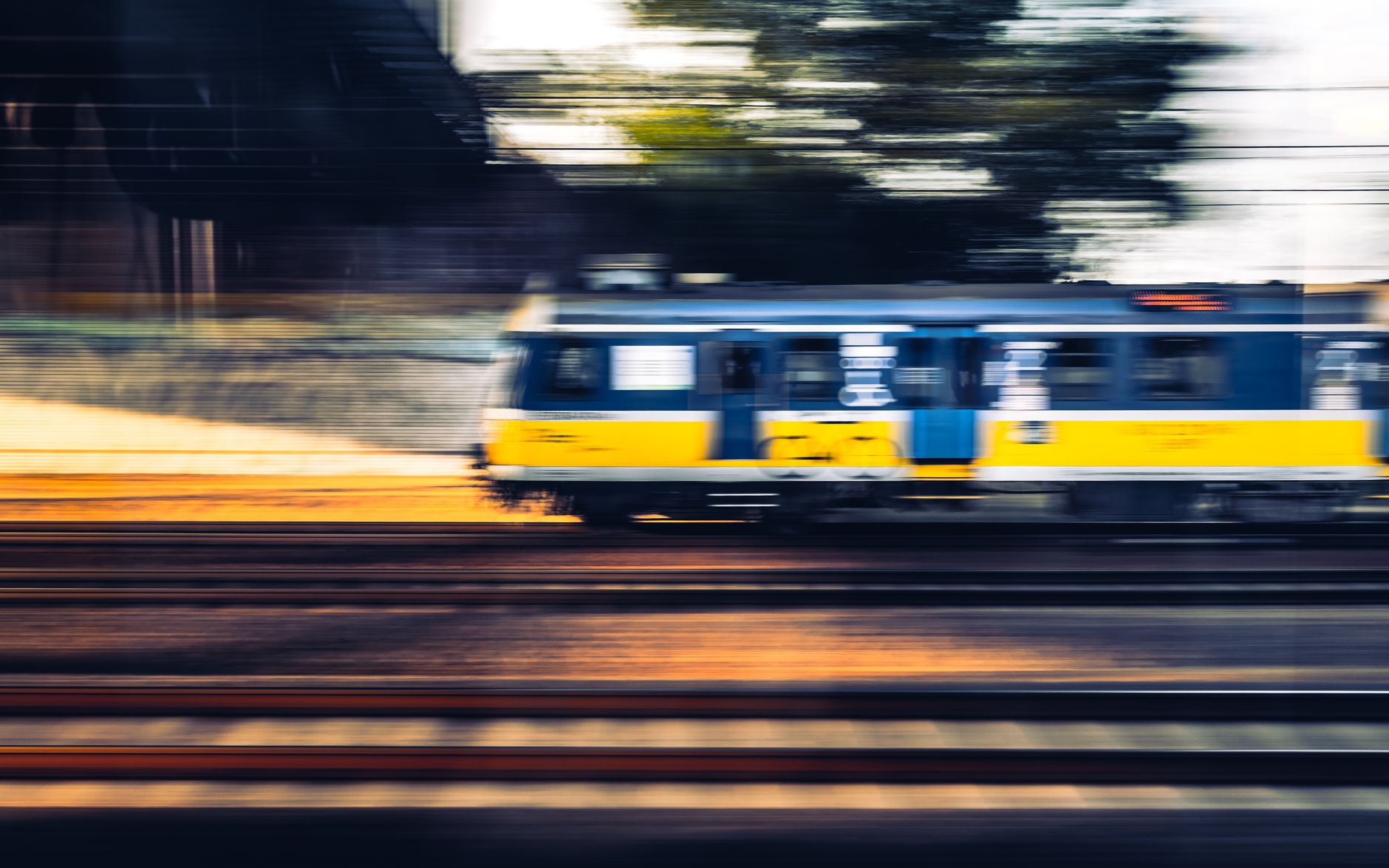 Blurred capture of a fast-moving train on Polish tracks showcasing speed and motion.