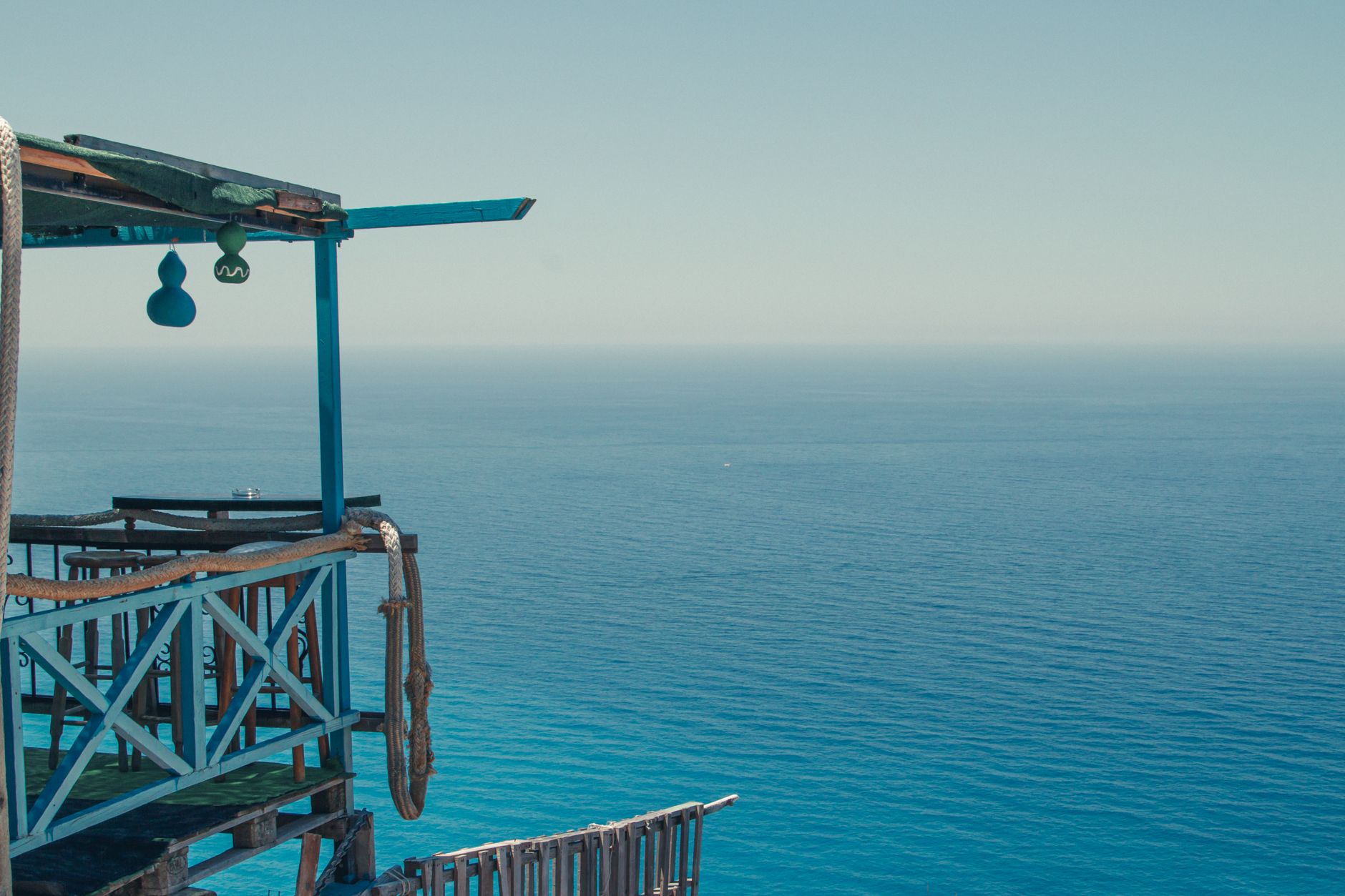Picturesque scenery of terrace of coastal house against endless blue rippling sea on sunny day