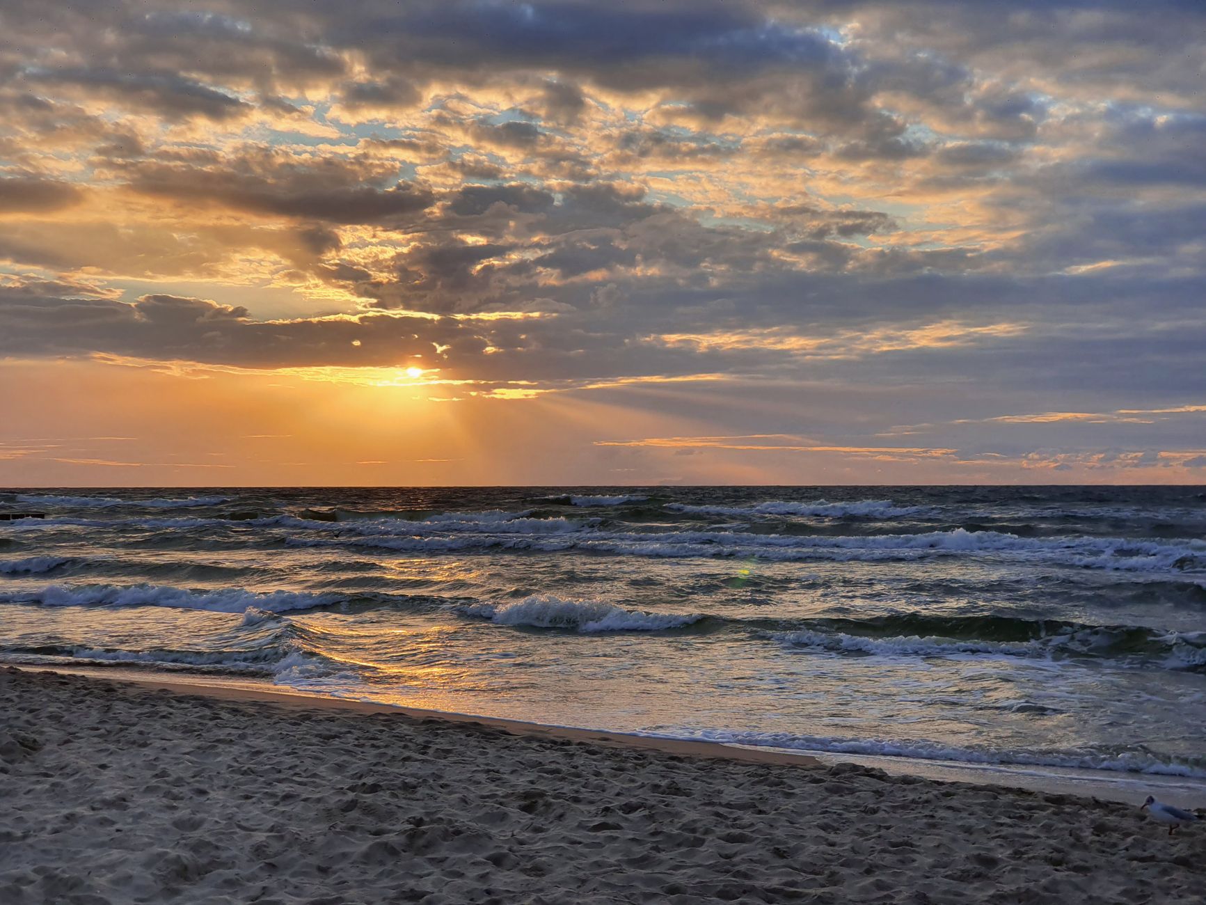 A stunning sunset view over the Baltic Sea at Dziwnówek beach, Poland.