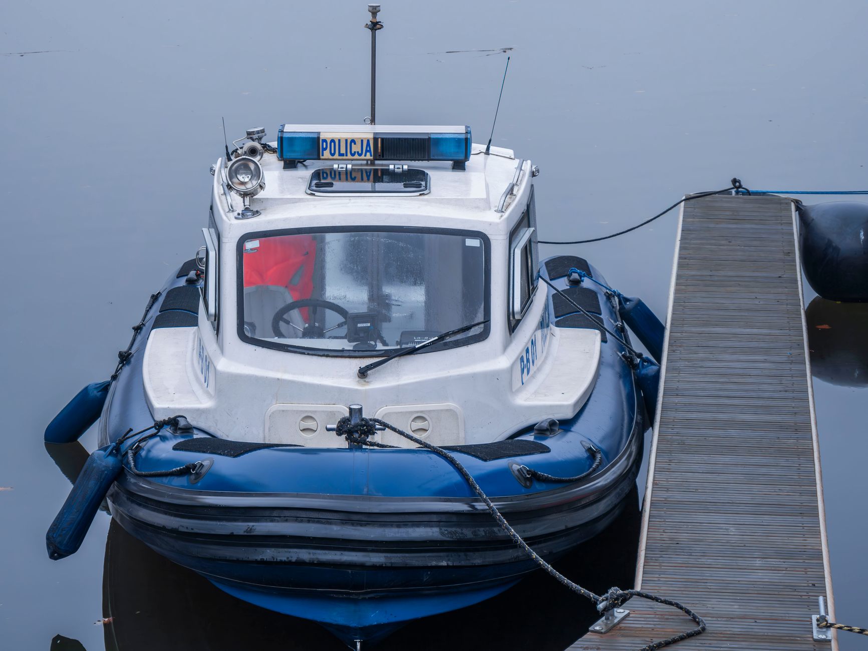 A Polish police boat docked, showcasing nautical safety and security.