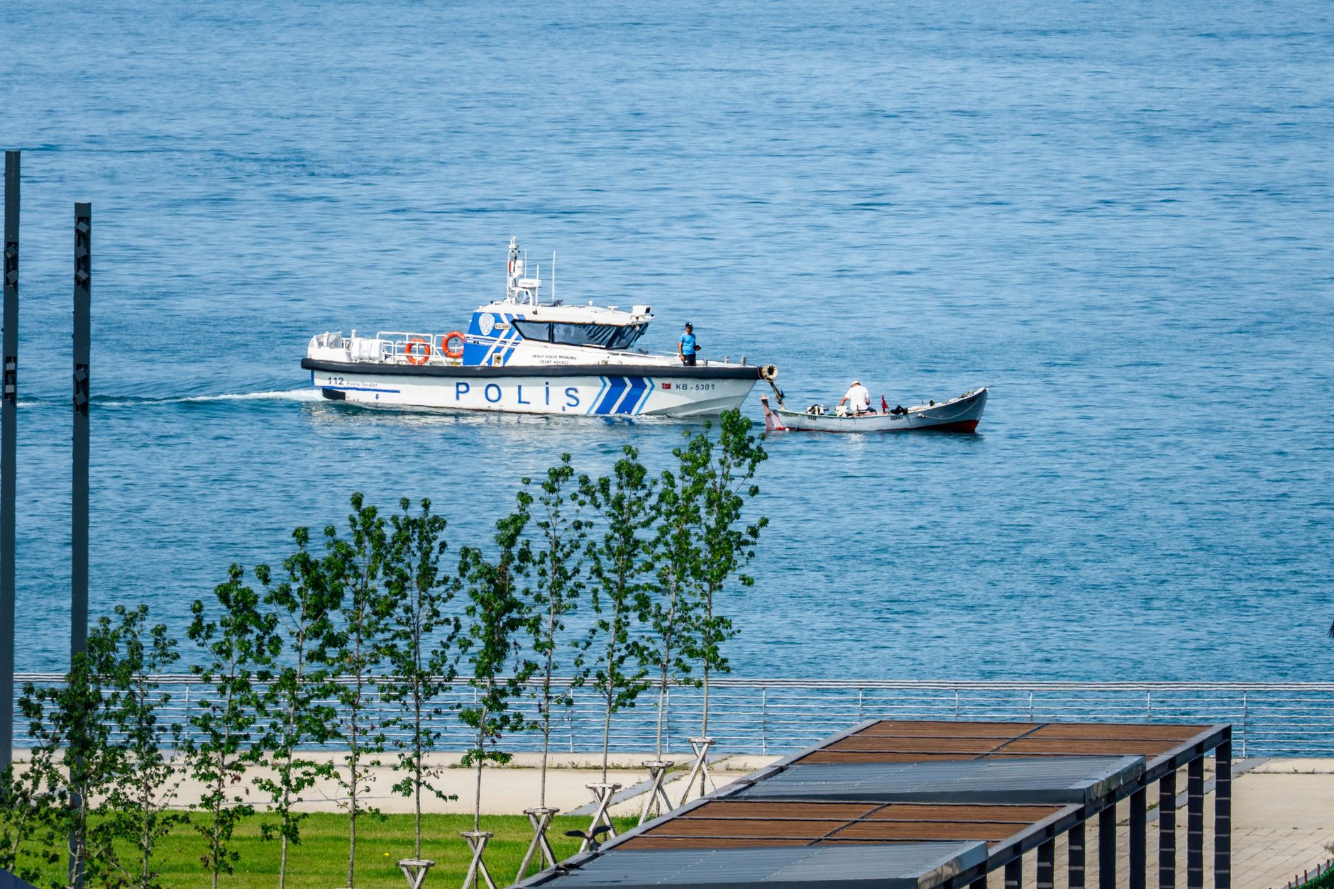 A police boat patrols the calm waters of the Black Sea in Rize, Türkiye, showcasing maritime security.