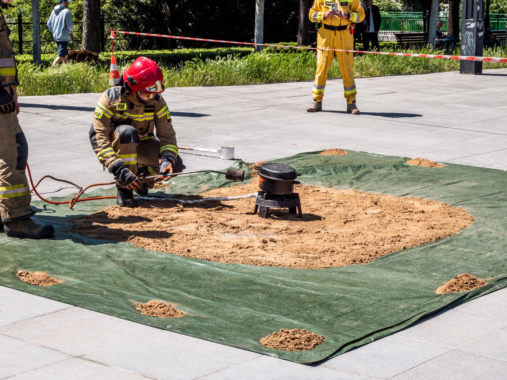 Firefighters in action demonstrating safety techniques in an outdoor setting.