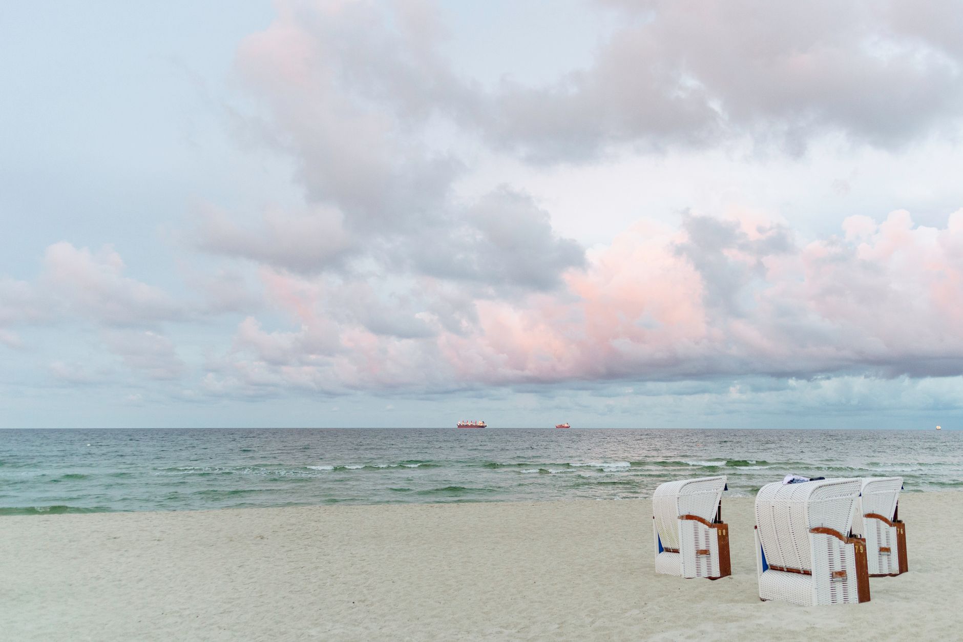 Serene beach scene at Binz, Germany with Strandkörbe and pastel skies.