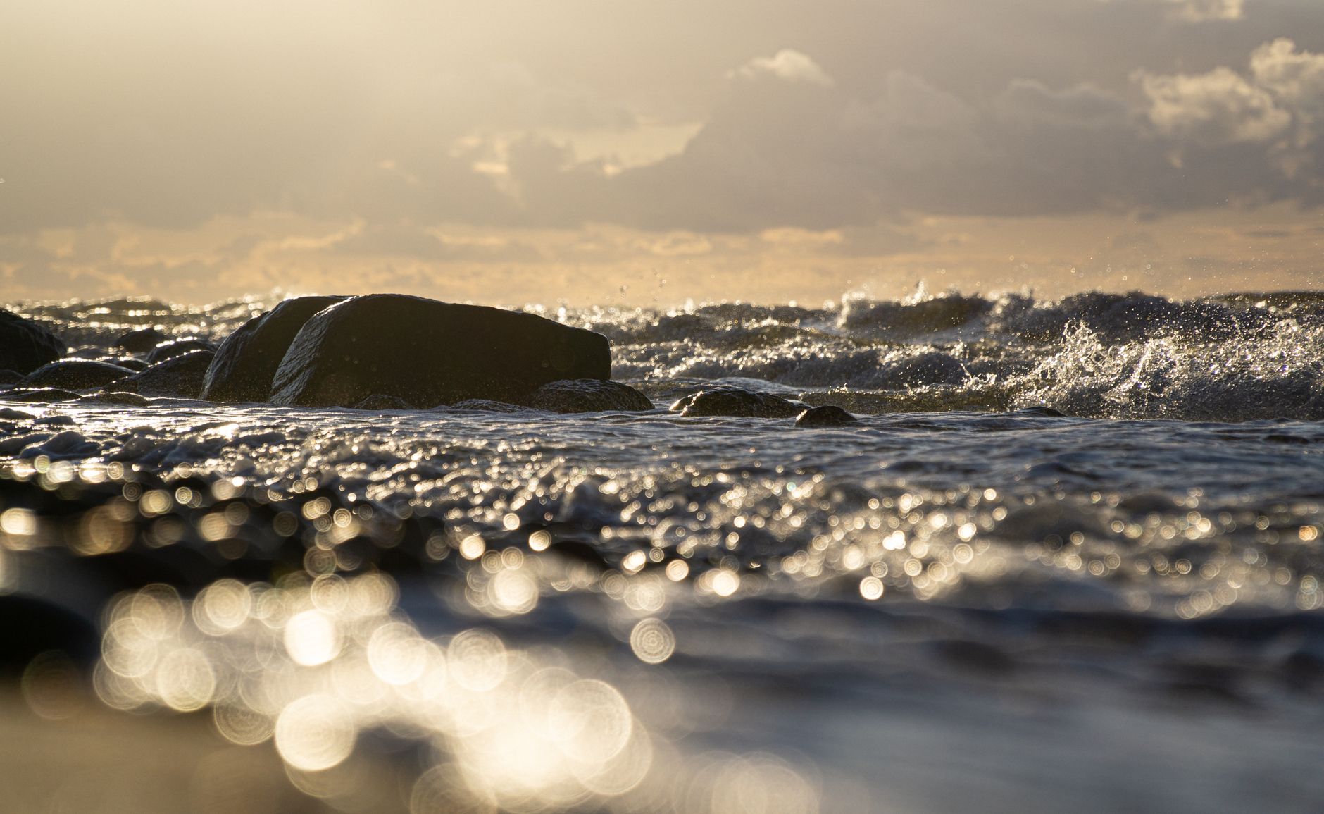 Captivating ocean waves crashing against rocks at sunset on the Baltic Sea, Rostock.