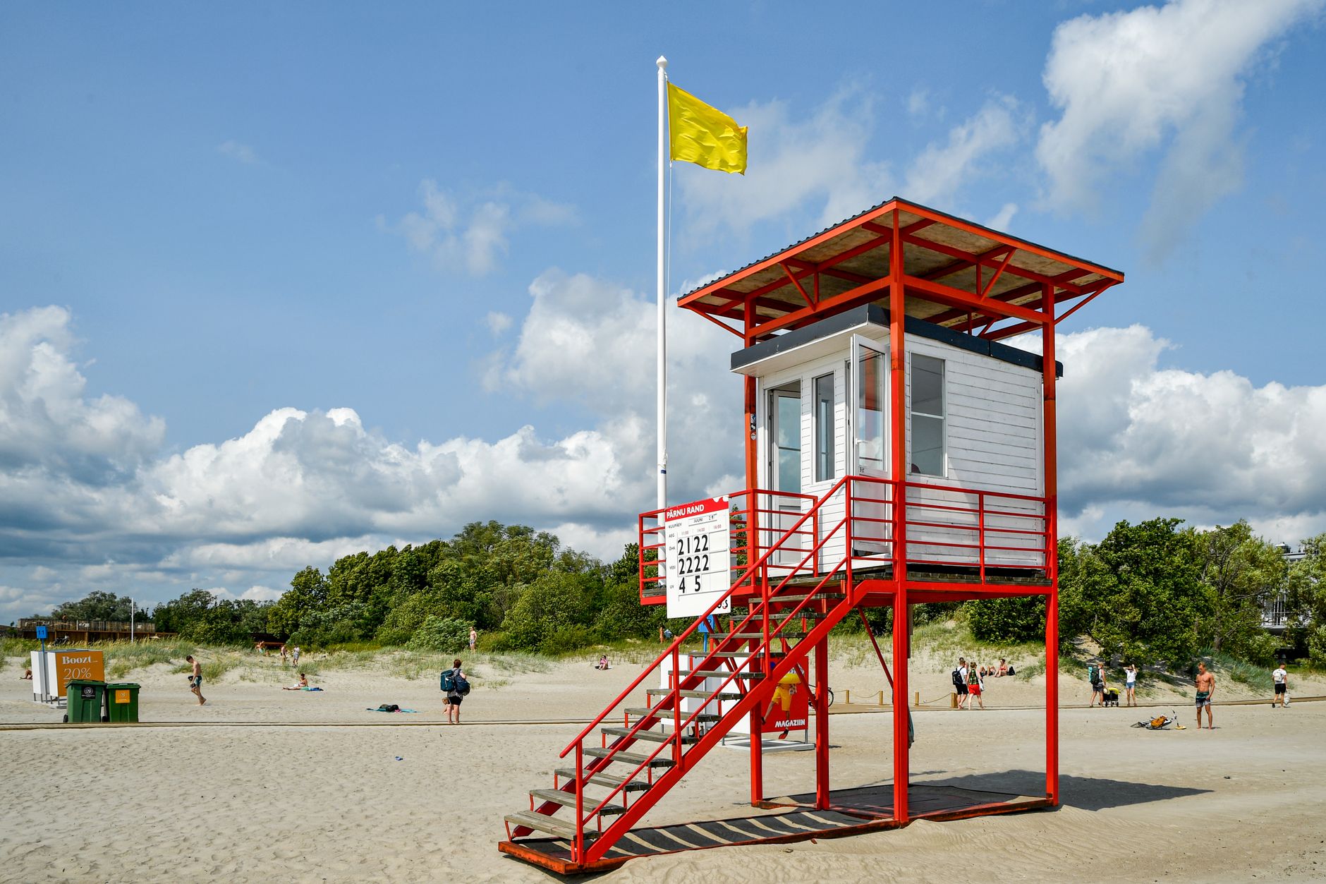 Vibrant lifeguard tower on a sunny day at Pärnu Beach in Estonia, offering a relaxing coastal scene.
