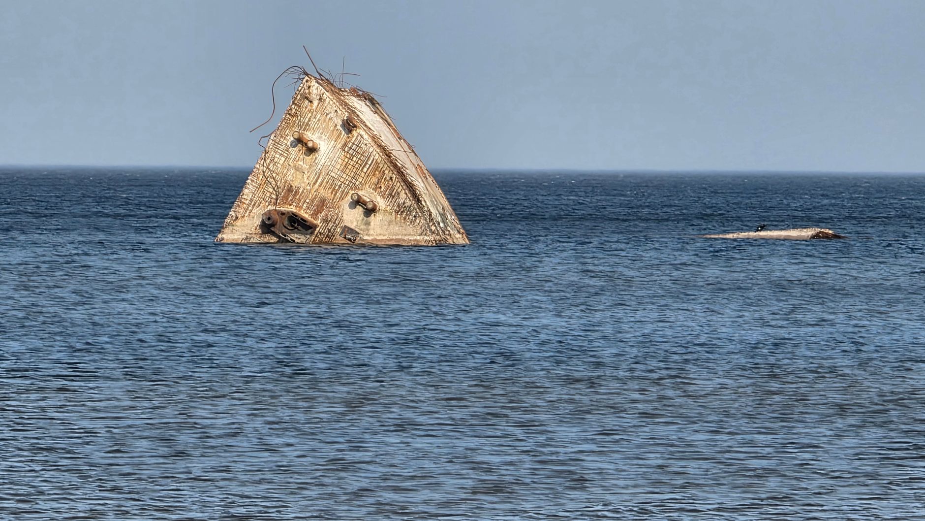 Partially submerged concrete structure creates an eerie focal point in the Baltic Sea waters.