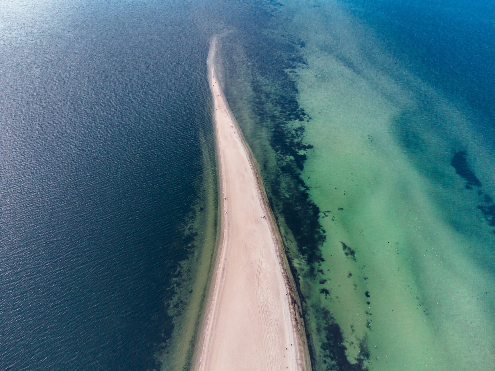 A breathtaking aerial photo of the Hel Peninsula stretching into the Baltic Sea in Poland.