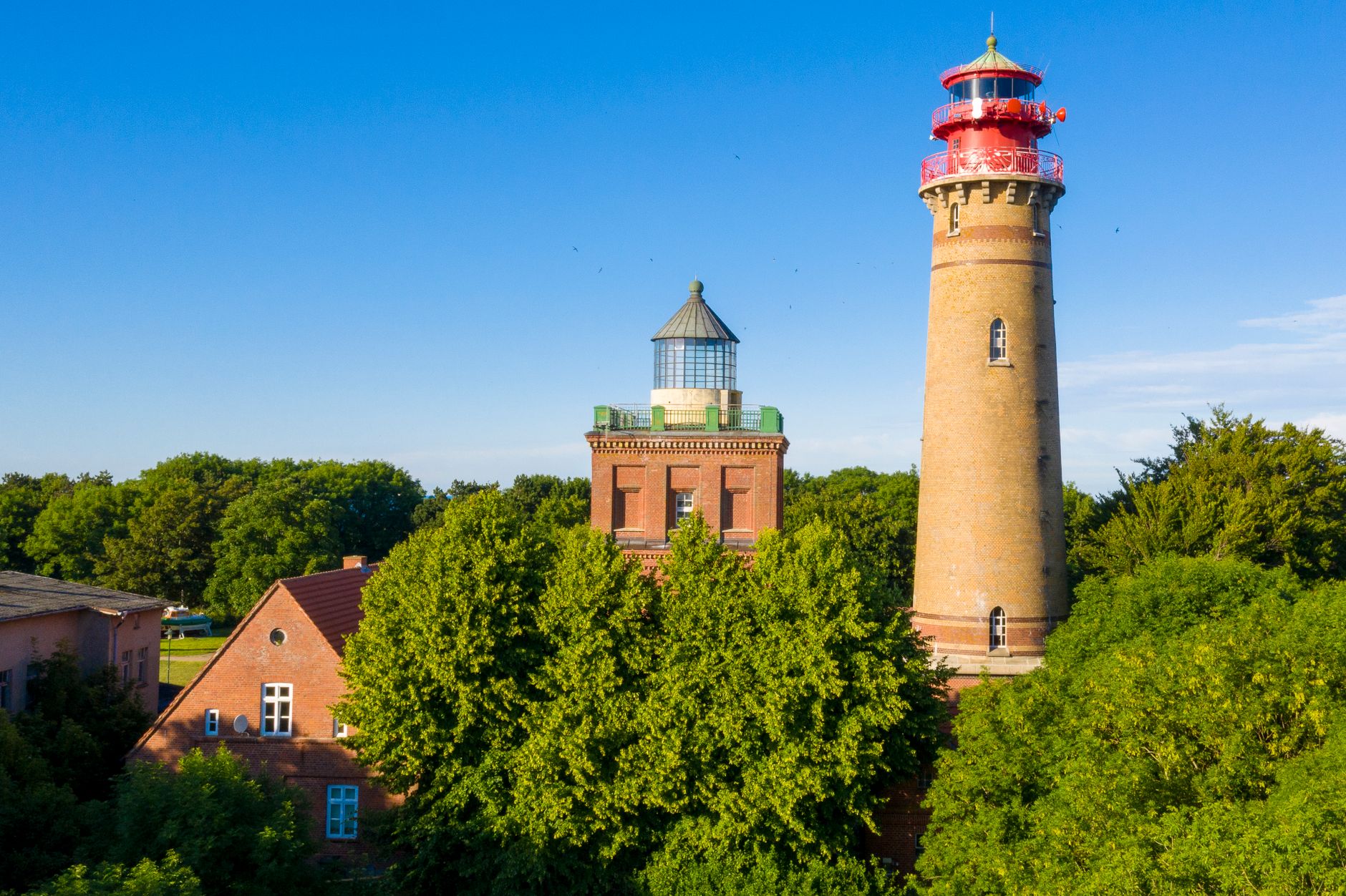 Beautiful summer view of Cape Arkona lighthouses on Rügen Island, Germany, under a clear blue sky.