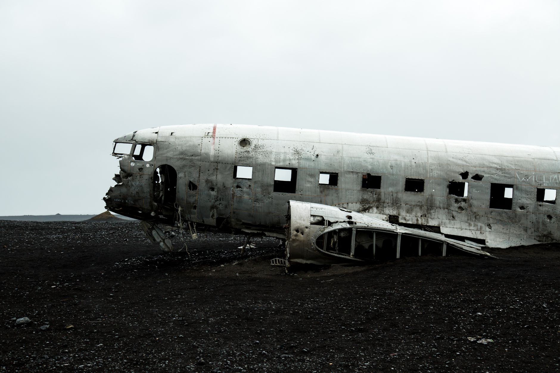 Rustic remains of a crashed plane on Solheimasandur black sand beach, Iceland.