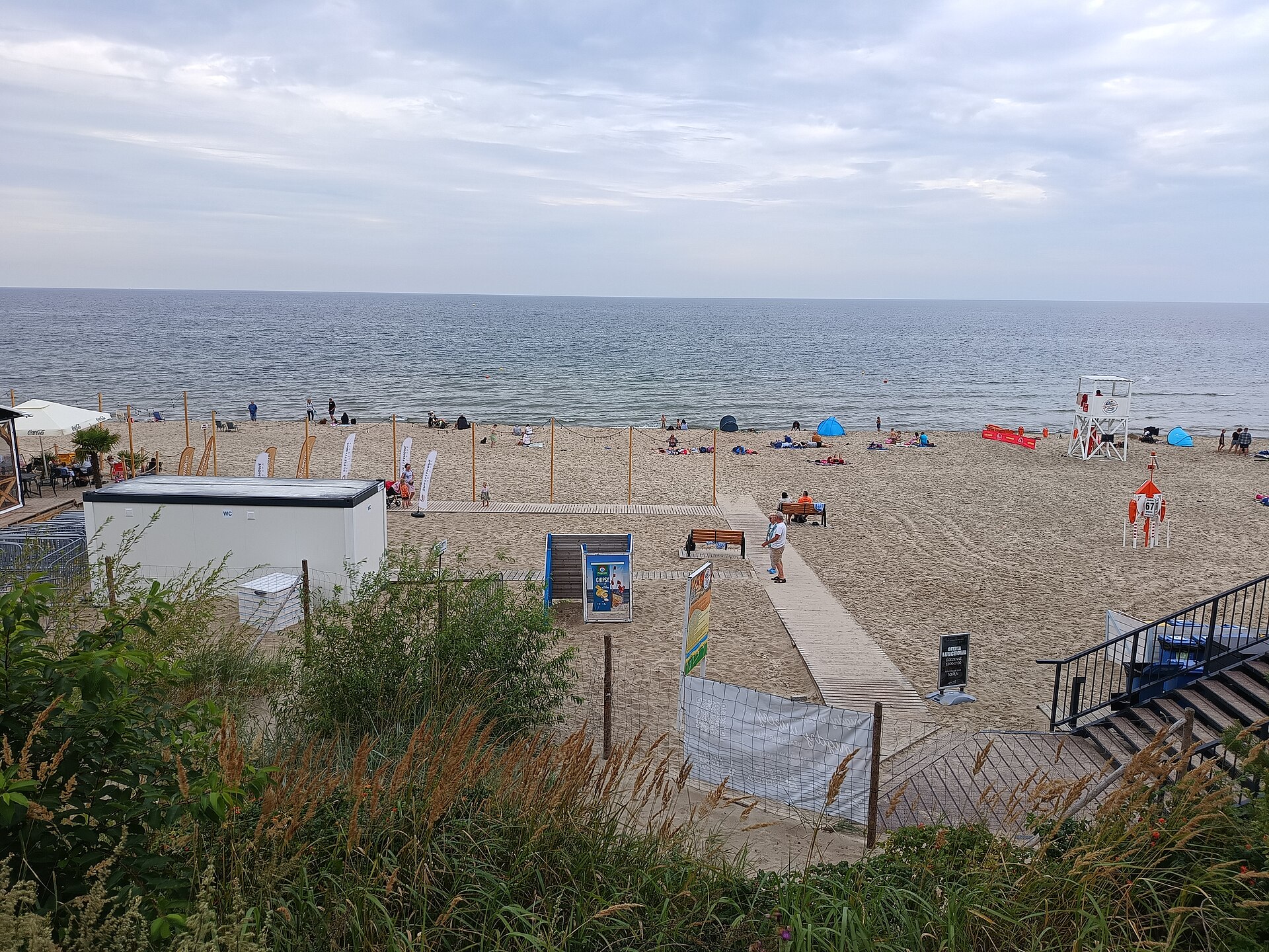 View of the sandy Baltic Sea beach in Stegna, Pomeranian Voivodeship, northern Poland, in August 2026. The photograph shows a lifeguard towe